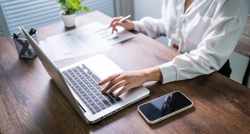 Woman working by using a laptop computer Hands typing on keyboard. writing a blog.